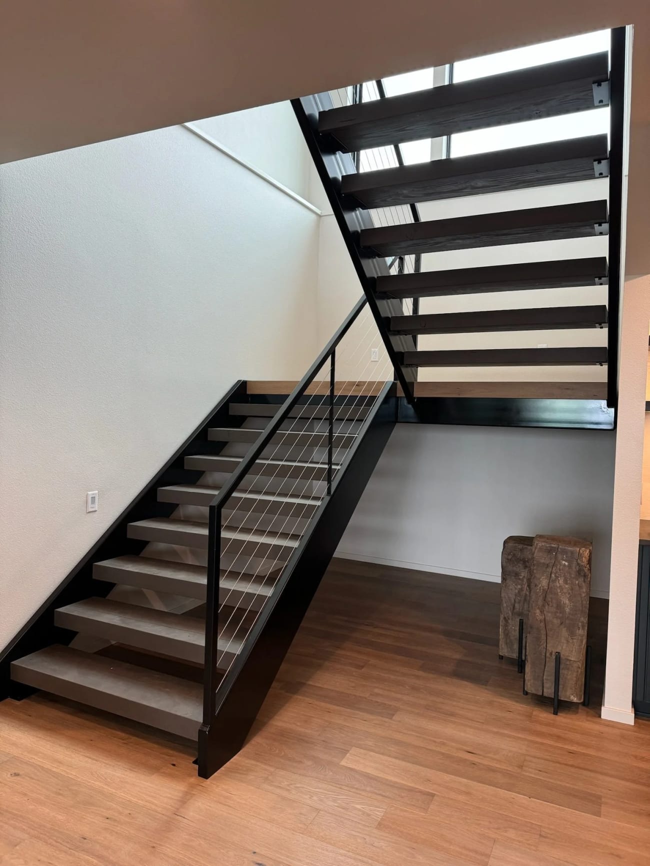 Stainless cable railing on a floating steel staircase